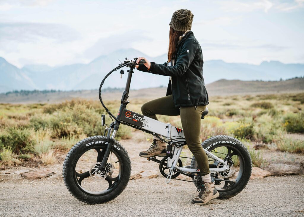 Woman riding an e-bike through scenic nature trails, embracing adventure and exploration.